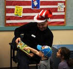 Volunteers from across the base read to children during the National Education Association’s “Read Across America” event on Minot Air Force Base, N.D., March 2-6, 2015. More than 90 Airmen and civilians volunteered at the Dr. Suess event.  This celebration occurs annually around Dr. Suess’ birthday. (U.S. Air Force photos/Senior Airman Kristoffer Kaubisch)