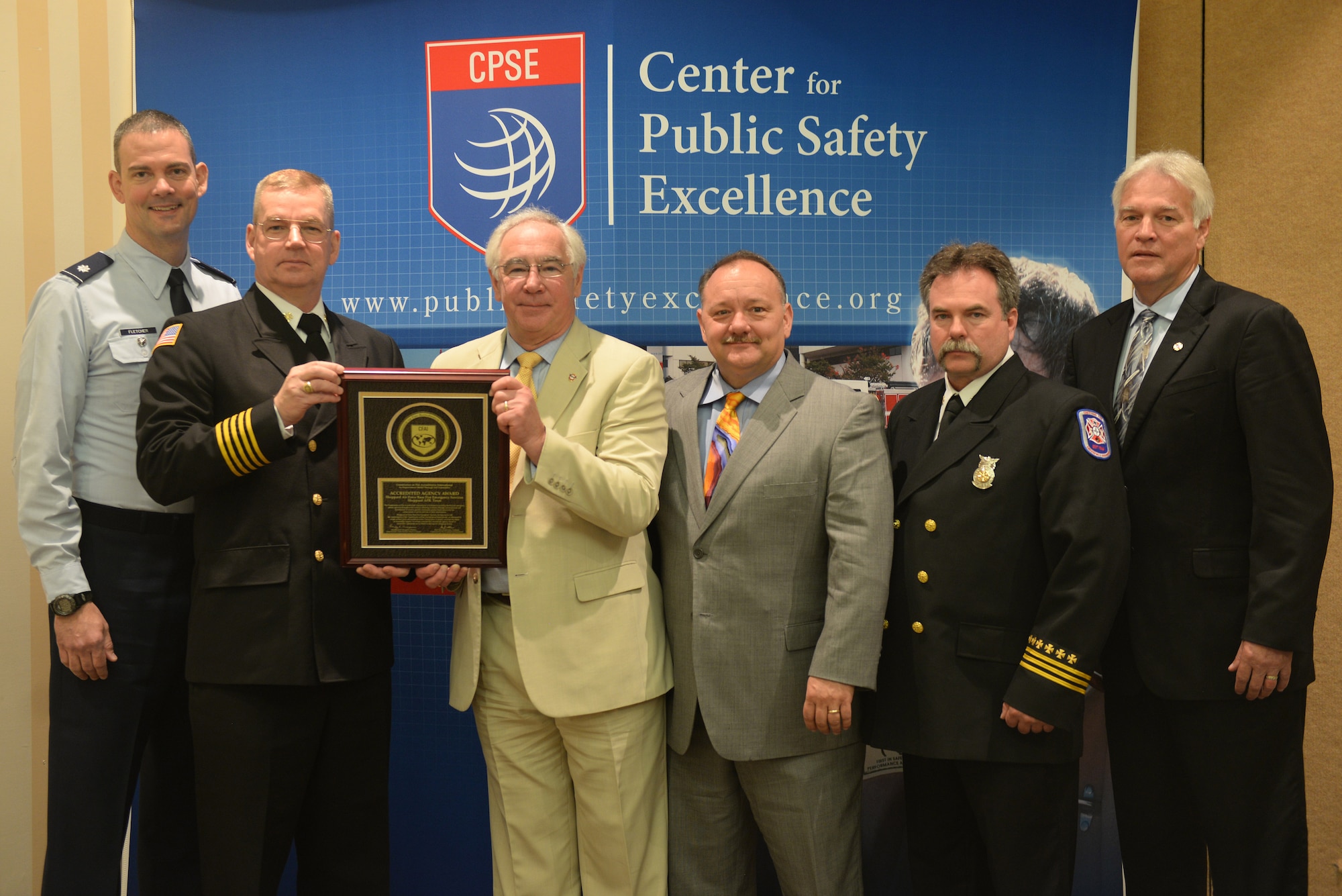 U.S. Air Force Lt. Col. Larry Fletcher, 82nd Training Wing Mission Support Group vice commander, David Mounsey, 82nd Training Wing fire chief, Steve Westermann, Center for Public Safety Excellence, Inc., Mark McBurnett, civil engineer, Robert Thompson, assistant chief of hazardous materials health and safety, all from Sheppard Air Force Base, Texas, and Jim Podolski, Air Force Fire Chief,  pose with the plaque Sheppard earned when the panel approved their accreditation at the Caribe Royale Hotel and Convention Center near Orlando, Fla., March 15, 2015.  Maxwell AFB, Ala., is the other AETC base to get accreditation during the days hearing. (U.S. Air Force photo by Tech. Sgt. Mike Meares)