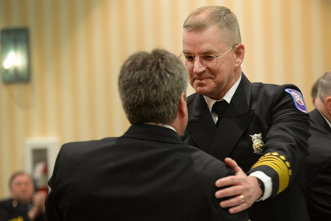 David Mounsey, 82nd Training Wing fire chief, congratulates Robert Thompson, Sheppard Air Force Base, Texas, assistant chief of hazardous materials health and safety, after a panel of 10 board members from the Commission on Fire Accreditation International approved the accreditation of Sheppard Fire Department at the Caribe Royale Hotel and Convention Center near Orlando, Fla., March 15, 2015. During the hearing, Sheppard earned accreditation and joined 201 other fire departments who’ve earned the distinction. Sheppard shares the achievement with Maxwell AFB, Ala., as being the first in Air Education and Training Command to earn the honor. (U.S. Air Force photo by Tech. Sgt. Mike Meares) 