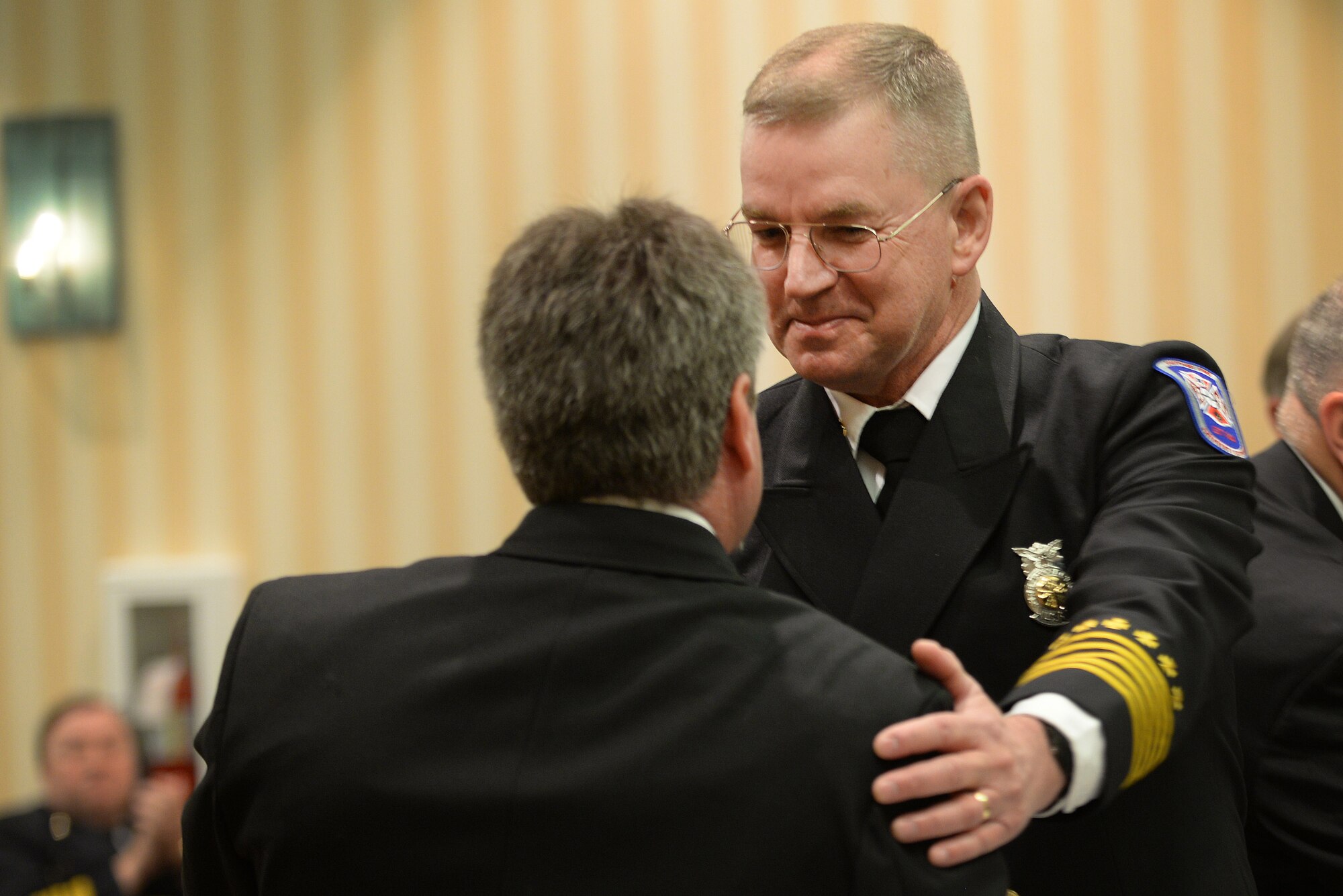 David Mounsey, 82nd Training Wing fire chief, congratulates Robert Thompson, Sheppard Air Force Base, Texas, assistant chief of hazardous materials health and safety, after a panel of 10 board members from the Commission on Fire Accreditation International approved the accreditation of Sheppard Fire Department at the Caribe Royale Hotel and Convention Center near Orlando, Fla., March 15, 2015. During the hearing, Sheppard earned accreditation and joined 201 other fire departments who’ve earned the distinction. Sheppard shares the achievement with Maxwell AFB, Ala., as being the first in Air Education and Training Command to earn the honor. (U.S. Air Force photo by Tech. Sgt. Mike Meares) 