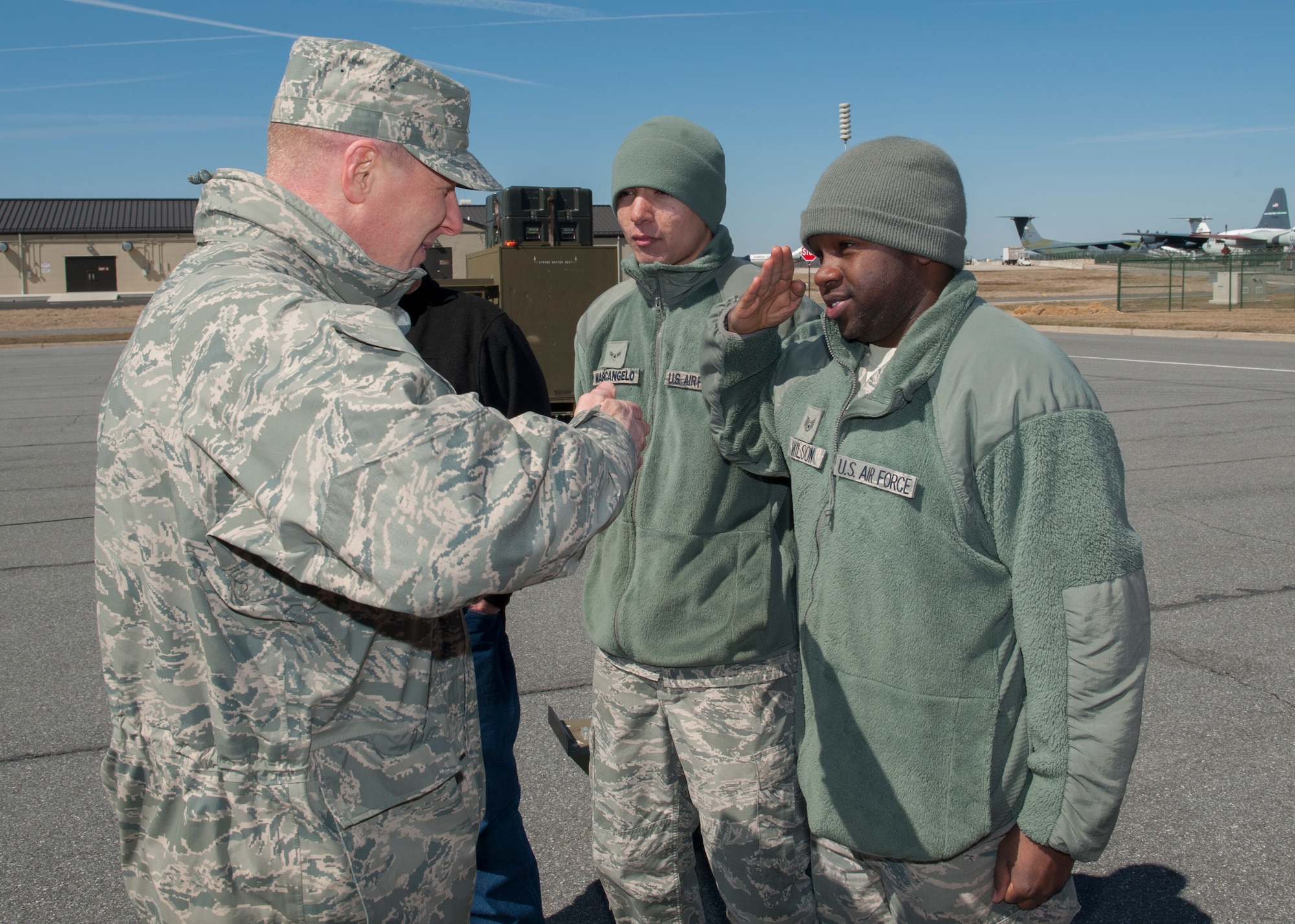 Staff Sgt. Kareem Wilson, 436th Civil Engineer Squadron electrician, salutes Col. Michael Grismer, 436th Airlift Wing commander, moments after receiving a commander’s coin March 18, 2015, at Dover Air Force Base, Del. Airman 1st Class Nicholas Marcangelo, 436th CES electrician, Pat Cox, 436th CES foreman, and Michael Underwood, 436th CES electrical planner, also received coins from Grismer. (U.S. Air Force photo/Airman 1st Class Zachary Cacicia) 