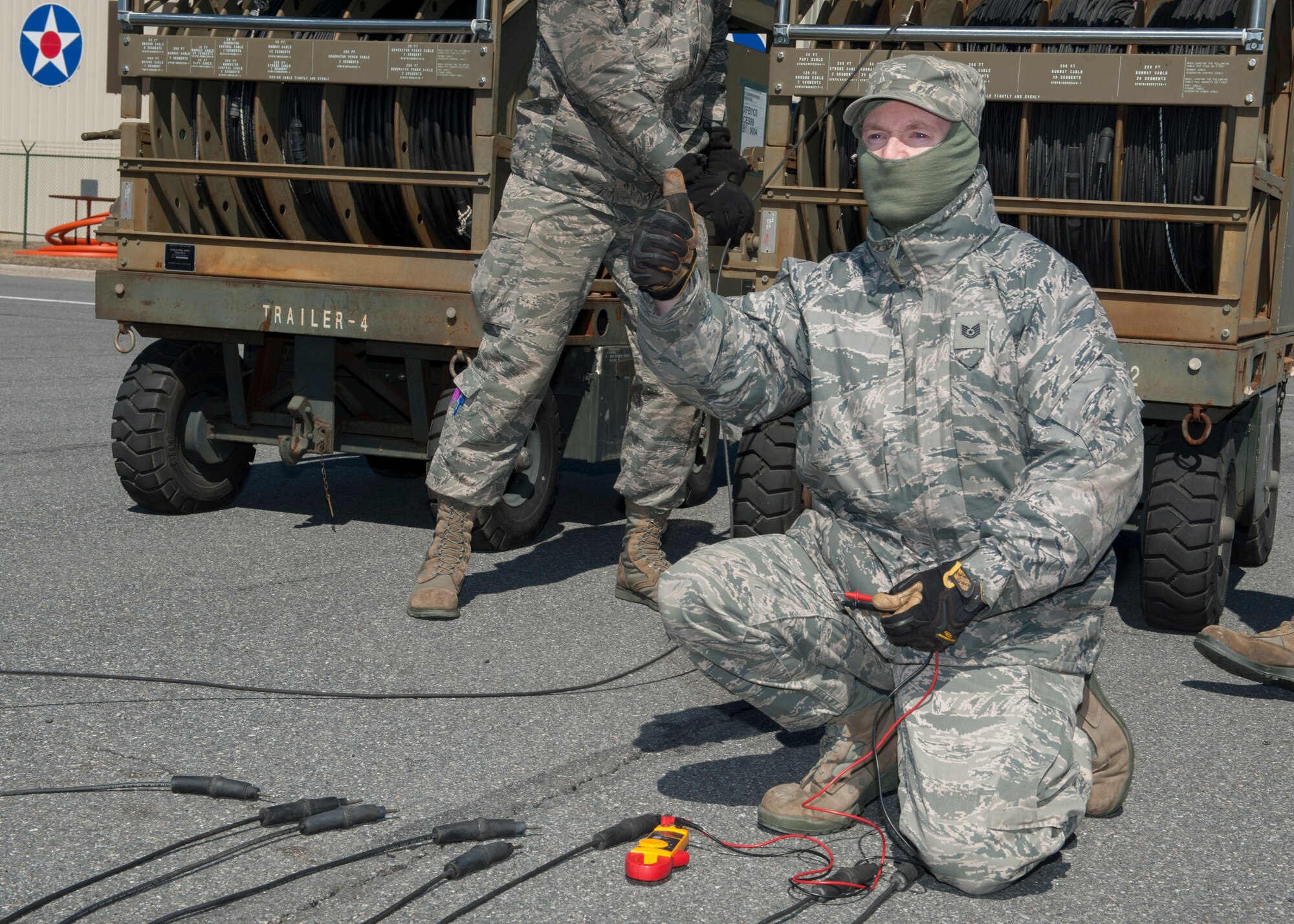 Tech. Sgt. Matthew Armstrong, 436th Civil Engineer Squadron electrician, gives the thumbs up after checking the voltage of an electrical cable March 18, 2015, at Dover Air Force Base, Del. The electric shop was inspecting the Emergency Airfield Lighting System for damage and wear-and-tear from use and transportation. (U.S. Air Force photo/Airman 1st Class Zachary Cacicia)