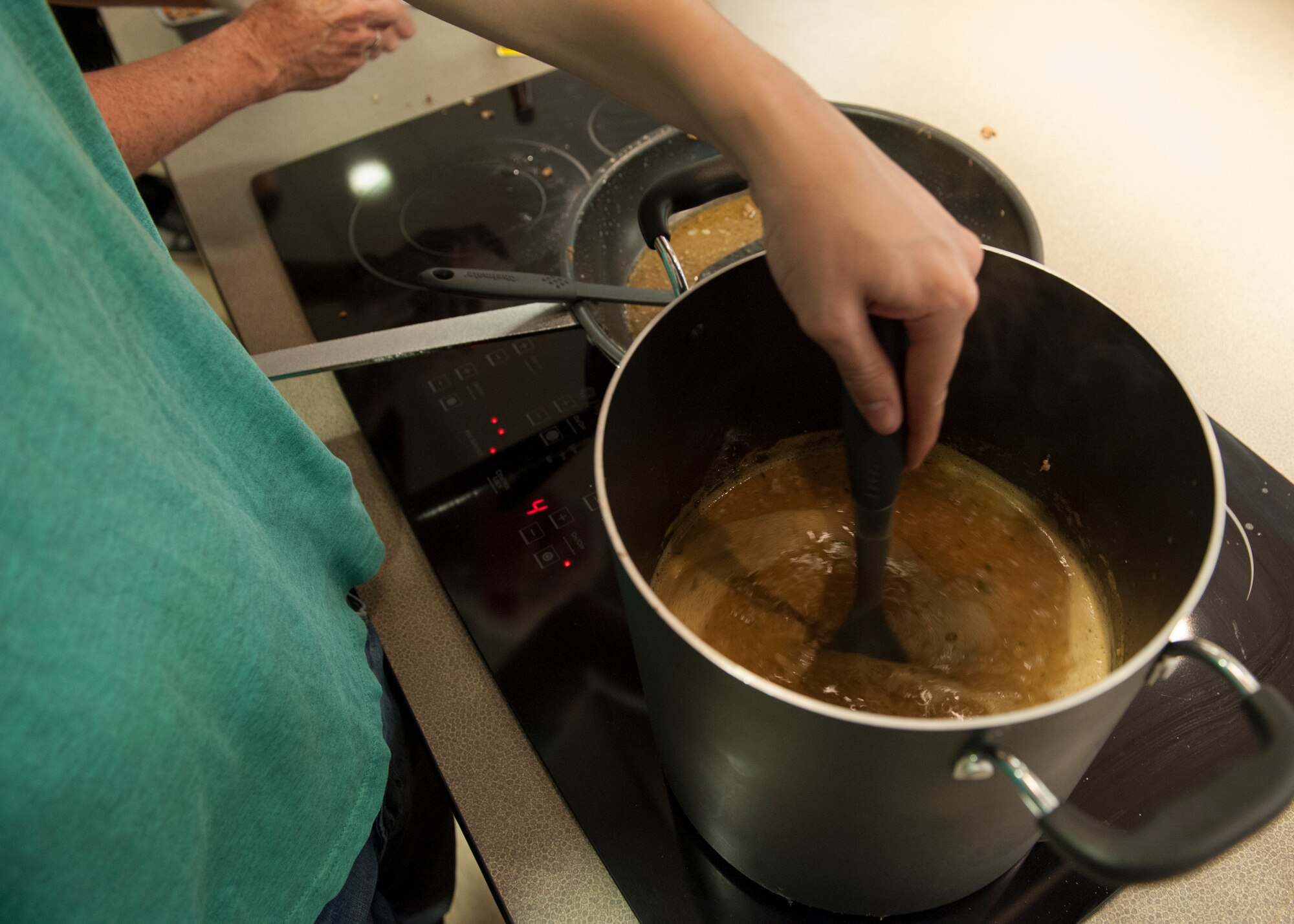 Airman 1st Class Mitch Dotson, 436th Aircraft Maintenance Squadron communication navigation technician, stirs a pot of chili during a “Dorm to Gourm” class March 17, 2015, at Dover Air Force Base, Del. The course teaches Airmen, who live in the dorms, how to cook healthy meals for themselves. (U.S. Air Force photo/Airman 1st Class Zachary Cacicia)