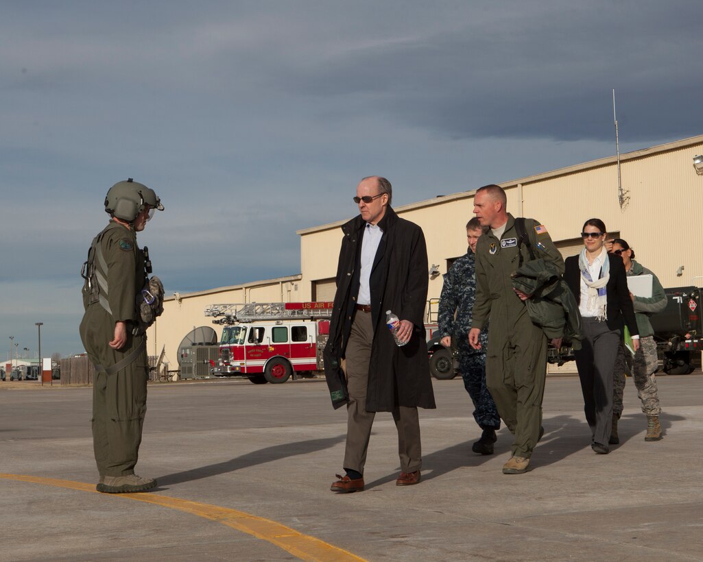 Brian McKeon (center), Principal Deputy Under Secretary of Defense for Policy, prepares to board a UH-1N Huey helicopter on the 37th Helicopter Squadron’s movement area during his visit to F.E. Warren Air Force Base, March 16, 2015. After a pre-departure briefing from the 90th Operations Group, in which he and missileers from the 90th Missile Wing received updates on the current environment, McKeon flew to a missile field to meet with Airmen and tour the facility. McKeon’s visit aligns with the Department of Defense’s efforts to review and assess the status and direction of the nuclear enterprise, as well as the morale and welfare of the Airmen who carry out the nuclear mission, following the publication of the Nuclear Enterprise Reviews in 2014. The 90th Missile Wing houses and maintains 150 of the Minuteman III inter-continental ballistic missiles used in support of U.S. Strategic Command’s strategic deterrence mission, as well as the command and control systems required to launch them. U.S. Strategic Command is one of nine U.S. Department of Defense unified combatant commands, and is responsible for strategic deterrence, space operations, cyberspace operations, joint electronic warfare, global strike, missile defense, intelligence, surveillance and reconnaissance, combating weapons of mass destruction, and analysis and targeting. (U.S. Air Force photo by Lan Kim)