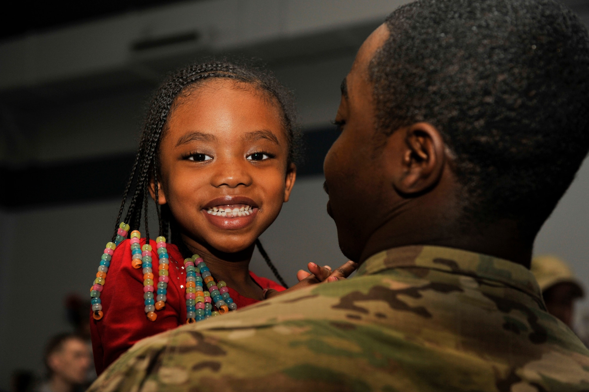 Aniya, 5, smiles as her father, Tech. Sgt. Anthony Duffin, a 19th Maintenance Squadron aircraft structural maintenance craftsman, embraces her. Duffin was deployed for approximately six months supporting operations in Afghanistan. (U.S. Air Force photo by Senior Airman Regina Edwards)