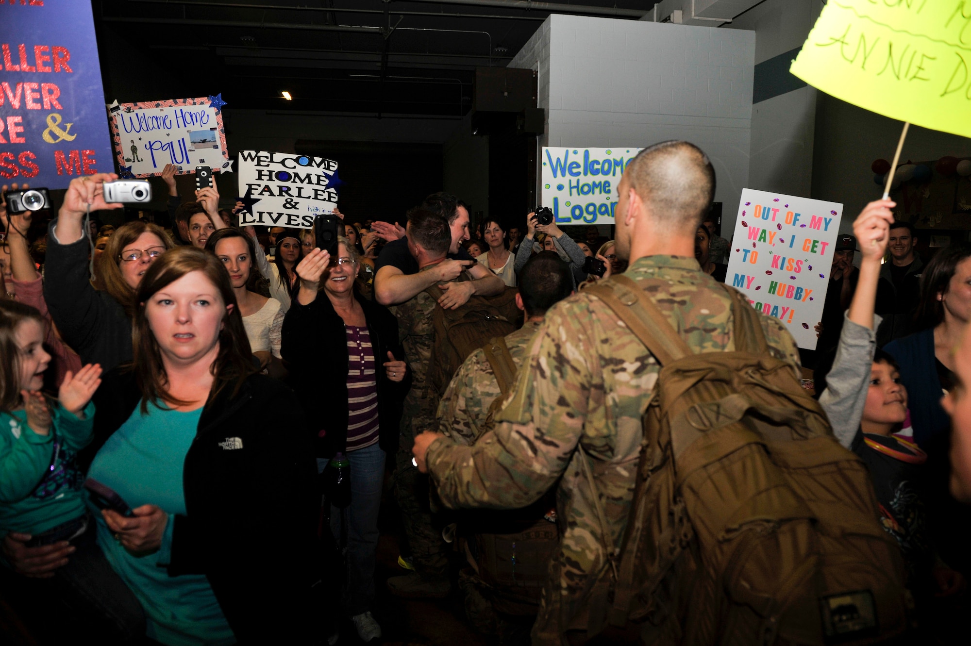 An excited crowd of family members and friends welcome Airmen back from deployment March 14, 2015, at Little Rock Air Force Base, Ark. More than 200 supporters cheered and applauded until the last Airman made it to their family. (U.S. Air Force photo by Senior Airman Regina Edwards)