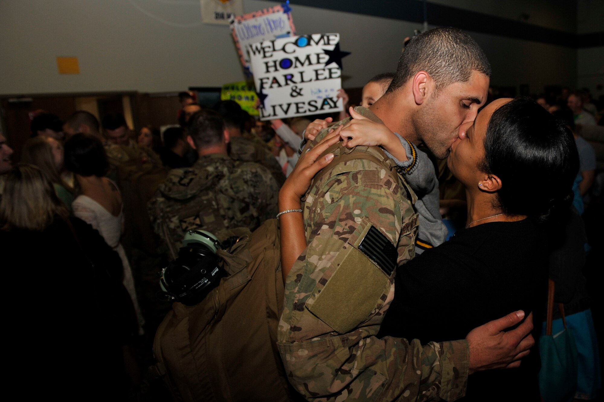 Precious Alexander, a 19th Airlift Wing paralegal legal assistant, embraces her husband, Staff Sgt. Alan Alexander, a 314th Aircraft Maintenance Squadron electronic and environmental systems specialist, March 14, 2015, at Little Rock Air Force Base, Ark.  Approximately 100 Airmen returned after supporting operations in Afghanistan. (U.S. Air Force photo by Senior Airman Regina Edwards)