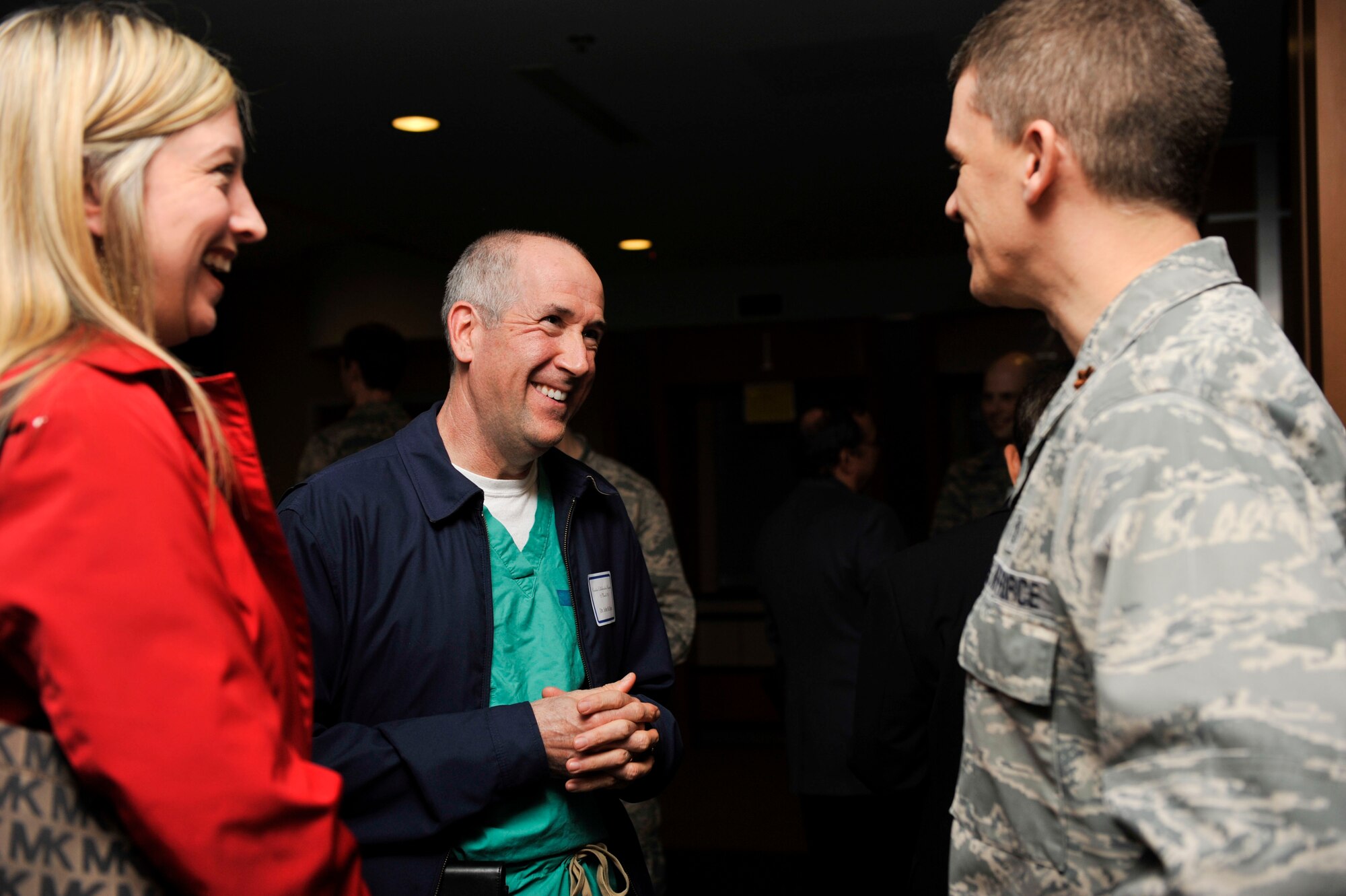 Carrie Peacock and Dr. John Hayes, both members of the Pulaski Surgery Center, talk with Maj. Ebon Alley, the 19th Medical Group menth health flight commander, March 12, 2015, at Little Rock Air Force Base, Ark. This event provided an opportunity for base medical professionals to build relationships with off-base providers through collaboration and exchange of ideas. (U.S. Air Force photo by Senior Airman Regina Edwards)  