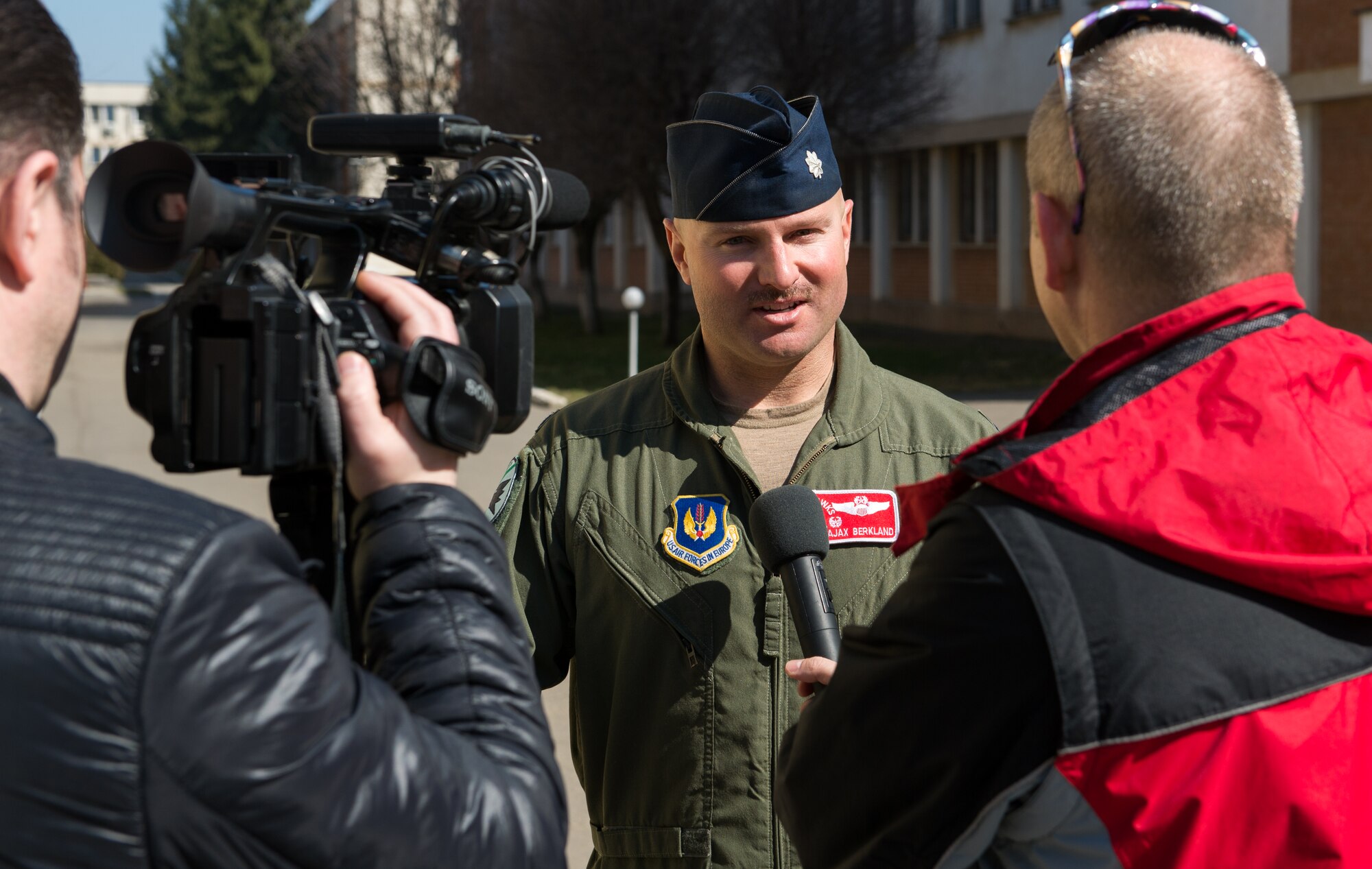 Lt. Col. David Berkland, 480th Fighter Squadron commander, is interviewed by local media during the training event Dacian Warhawk at Campia Turzii, Romania, March 17, 2015. Dacian Warhawk is a bilateral training event designed to increase interoperability and build relationships between Romanian and U.S. Airmen. (U.S. Air Force photo/ Staff Sgt. Armando A. Schwier-Morales) 
