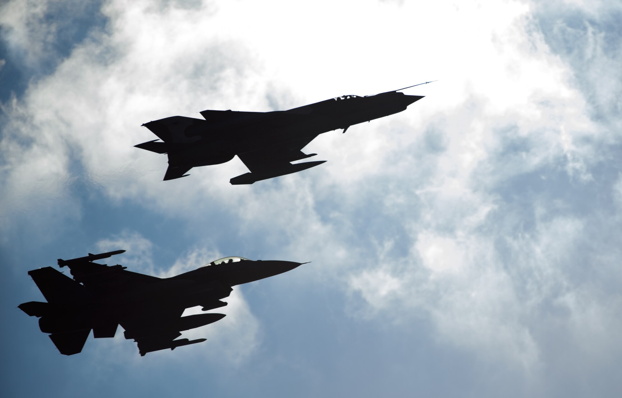 A U.S. F-16CJ Fighting Falcon and a Romanian MiG-21 fly in formation after conducting training at Campia Turzii, Romania, March 17, 2015. U.S. and Romanian fighter pilots conducted air to air training as part of Dacian Warhawk, a two-week bilateral training mission designed to increase the interoperability between the U.S. and Romania. (U.S. Air Force photo/Staff Sgt. Armando A. Schwier-Morales)