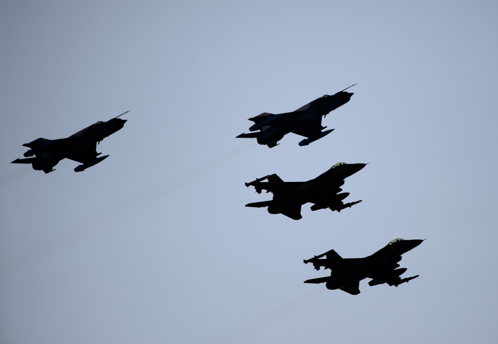 Two U.S. Air Force F-16CJ Fighting Falcons and two Romanian MiG-21s fly in formation over Campia Turzii, Romania, after conducting an air training scenario March 17, 2015. The bilateral training event, Dacian Warhawk, trained both Airmen in the skies and on the ground to help provide increased security in the Easter European region. (U.S. Air Force photo/Staff Sgt. Armando A. Schwier-Morales)