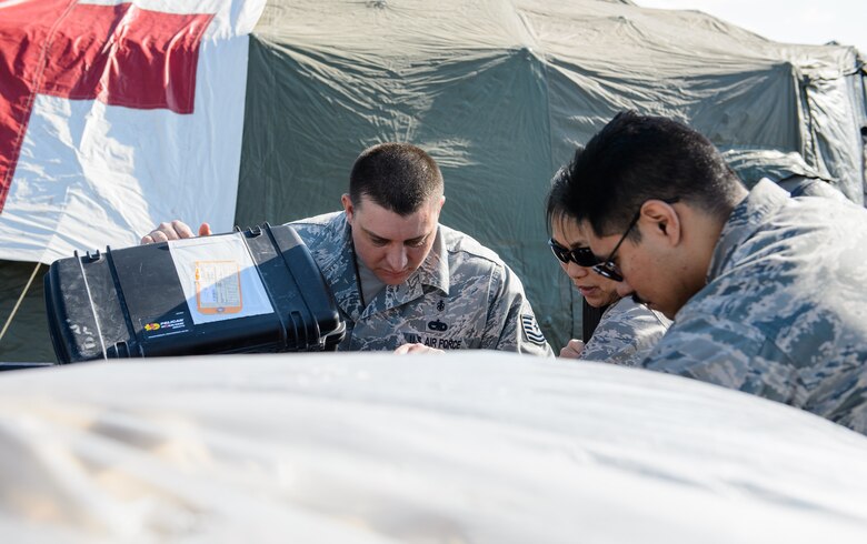 Tech Sgt. Timothy Hoffma, bioenvironmental technician, left, Lt. Col. Peerach Ewings, flight surgeon and Capt. Ulises Atilano, public health officer, all from Detachment 1, 435th Contingency Response Group, inventory medical supplies during Dacian Warhawk, a two-week training mission designed to increase the interoperability between the U.S. and Romania at Campia Turzii, Romania, March 16, 2015. The medics ensured all the materials were available for set up of the expeditionary clinic. (U.S. Air Force photo/Staff Sgt. Armando A. Schwier-Morales)