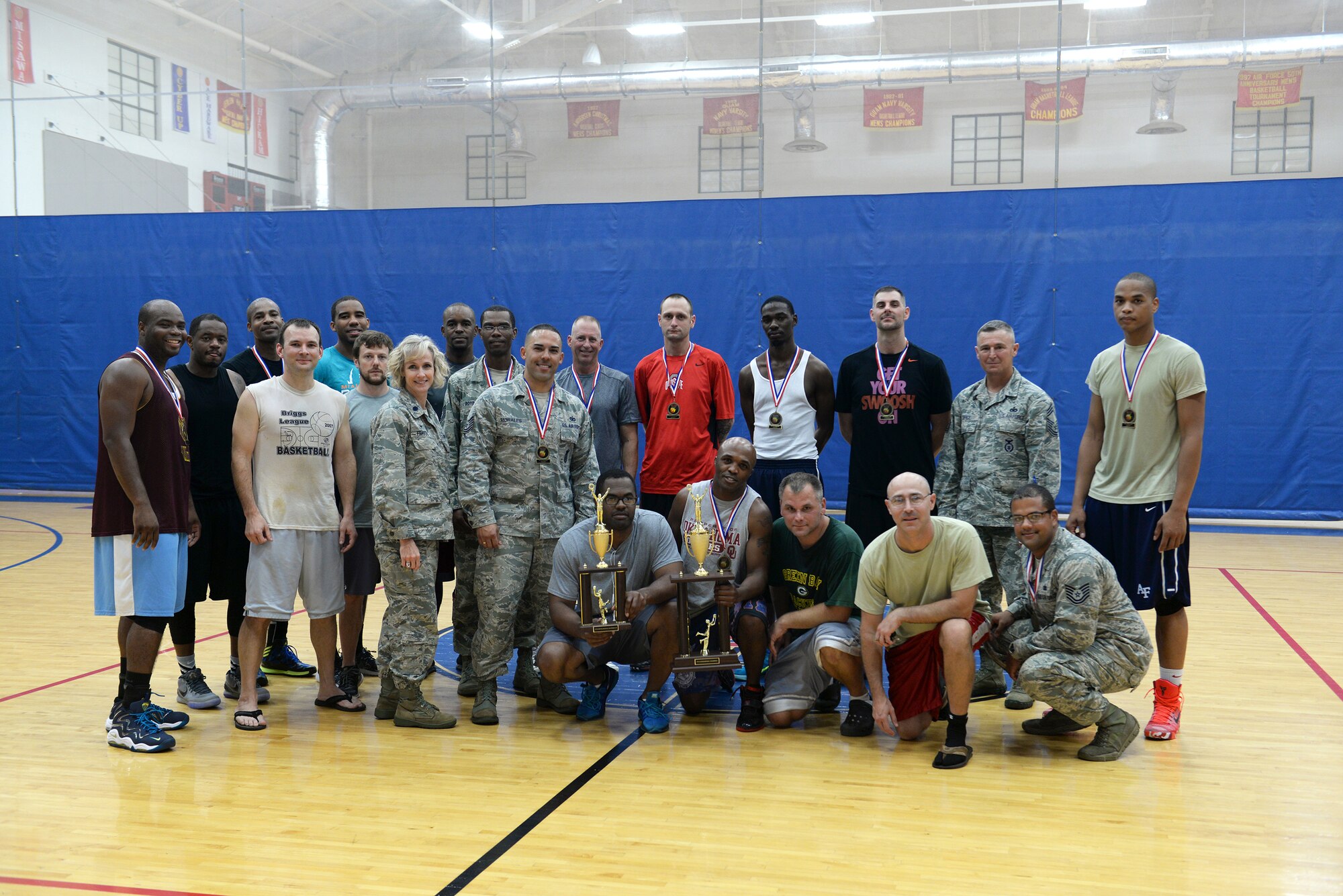 Members of the 36th Security Forces Squadron and the 36th Medical Group gather for a group photo after competing in the over-thirty basketball championship March 12, 2015, at Andersen Air Force Base, Guam. The 36th SFS defeated the 36th MDG 57-56 to win the championship overall. (U.S. Air Force photo by Senior Airman Amanda Morris/Released)