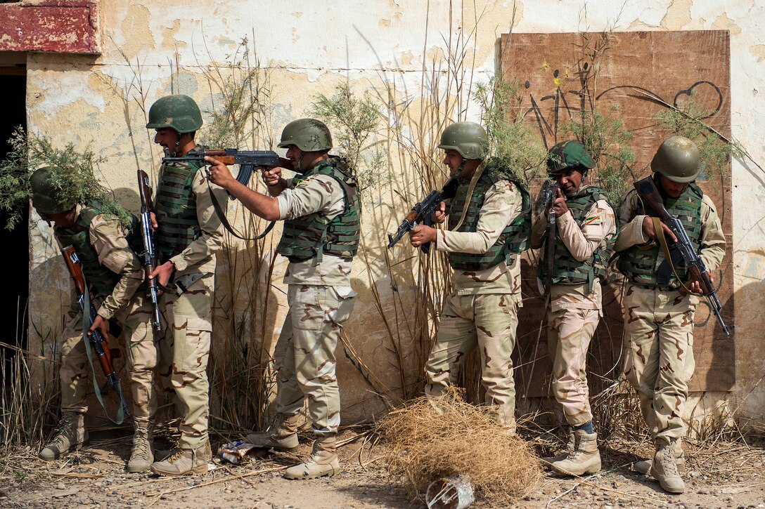 Iraqi army soldiers gather during close-quarters battle training on Camp Taji, Iraq, March 12, 2015. The Iraqi soldiers are training with U.S. soldiers for deployment to northern Iraq. 