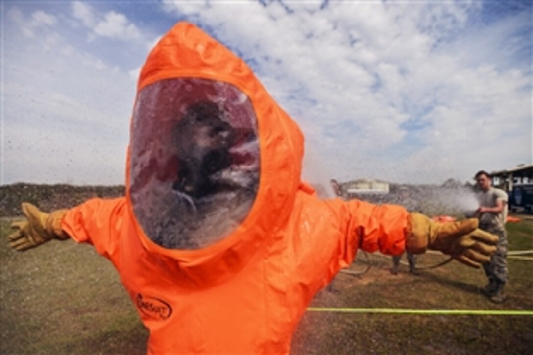 Air Force Staff Sgt. Marjorie Hoover goes through a decontamination procedure after an attempt to identify radioactive contaminants in a passenger train during a Global Dragon training event in Perry, Ga., March 18, 2015. The training provides a refresher course for airmen, allowing them to identify live chemical, biological, radiological and nuclear agents and materials. Hoover is assigned to the 151st Air Refueling Wing. 
