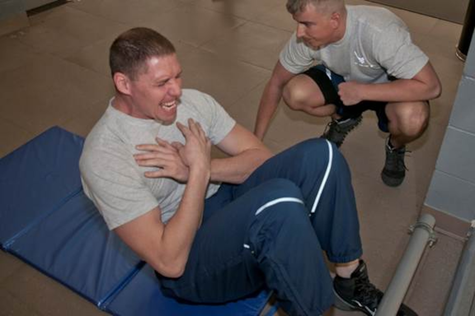 U.S. Air Force Senior Airman Allen Wright, a pavements and equipment operator assigned to the 307th RED HORSE performs sits ups during his physical fitness assessment at the Bell Fitness Center on Barksdale Air Force Base, La., Mar. 7, 2015. Each Airman must complete a one and a half mile run, a minimum number of pushups, and sit-ups in one minute, as well as meet an abdominal circumference measured. (U.S. Air Force photo by Master Sgt. Jeff Walston/Released)    