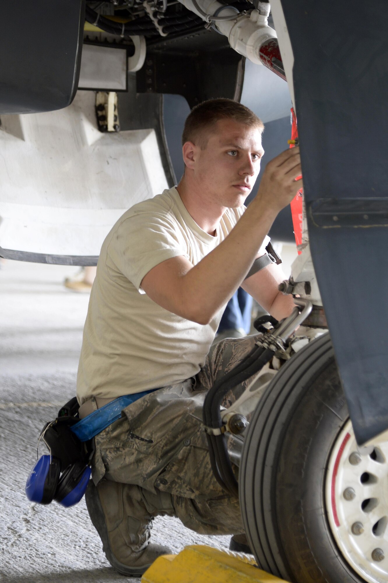 Airman 1st Class Anthony, crew chief, checks the RQ-4 Global Hawk landing gear strut for cracks during a post flight inspection at an undisclosed location in Southwest Asia Mar. 8, 2015. Hawk Aircraft Maintenance Unit Airmen provide combat ready safe and reliable aircraft for the warfighter. Anthony is currently deployed from Grand Forks Air Force Base, N.D. (U.S. Air Force photo/Tech. Sgt. Marie Brown)