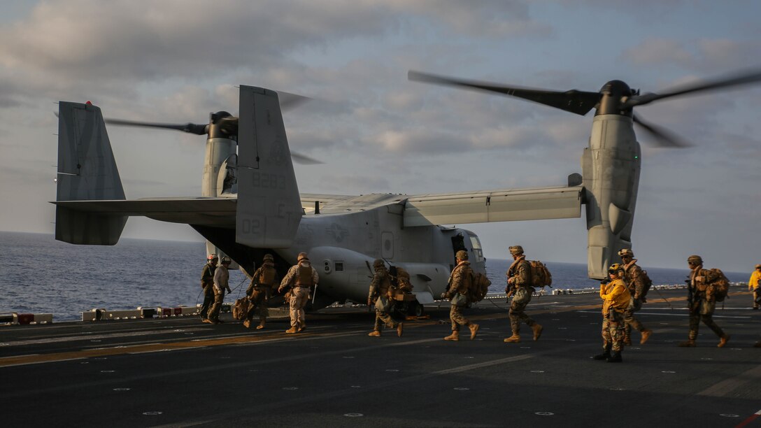 U.S. Marines walk towards a MV-22B Osprey on the flight deck of the USS Bonhomme Richard (LHD 6) March 19, 2015. The Marines are preparing for a vertical assault exercise on Ie Shima, Okinawa, Japan. The Ospreys are with Marine Medium Tiltrotor Squadron 262, 31st Marine Expeditionary Unit. The Marines are with Company E., Battalion Landing Team 2nd Battalion, 4th Marines, 31st MEU and are currently participating in Certification Exercise during their Spring Patrol of the Asia-Pacific region.