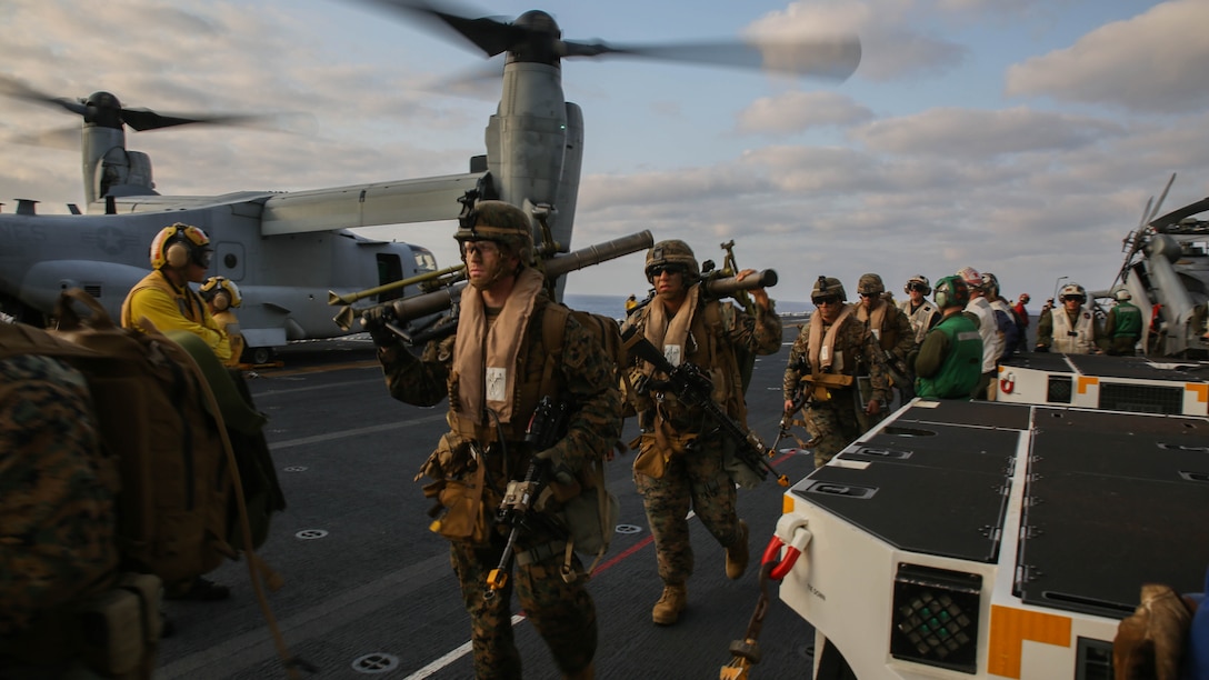 U.S. Marines walk toward MV-22B Ospreys on the flight deck of the USS Bonhomme Richard (LHD 6), at sea, March 19, 2015. The Marines are preparing for a vertical assault exercise on Ie Shima, Okinawa, Japan. The Ospreys are with Marine Medium Tiltrotor Squadron 262 (Reinforced), 31st Marine Expeditionary Unit. The Marines are with Company E, Battalion Landing Team 2nd Battalion, 4th Marines, 31st MEU, and are currently participating in Certification Exercise during their Spring Patrol of the Asia-Pacific region. 