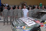 The eight National Guard members from 8 Soldiers and 8 Missions stand with Dale Earnhardt Jr., after the unveiling his car, June 30, 2010. This weekend, Earnhardt's No. 88 National Guard Chevrolet will feature a special paint scheme in honor of the 8 Soldiers and 8 Missions in which they served.
