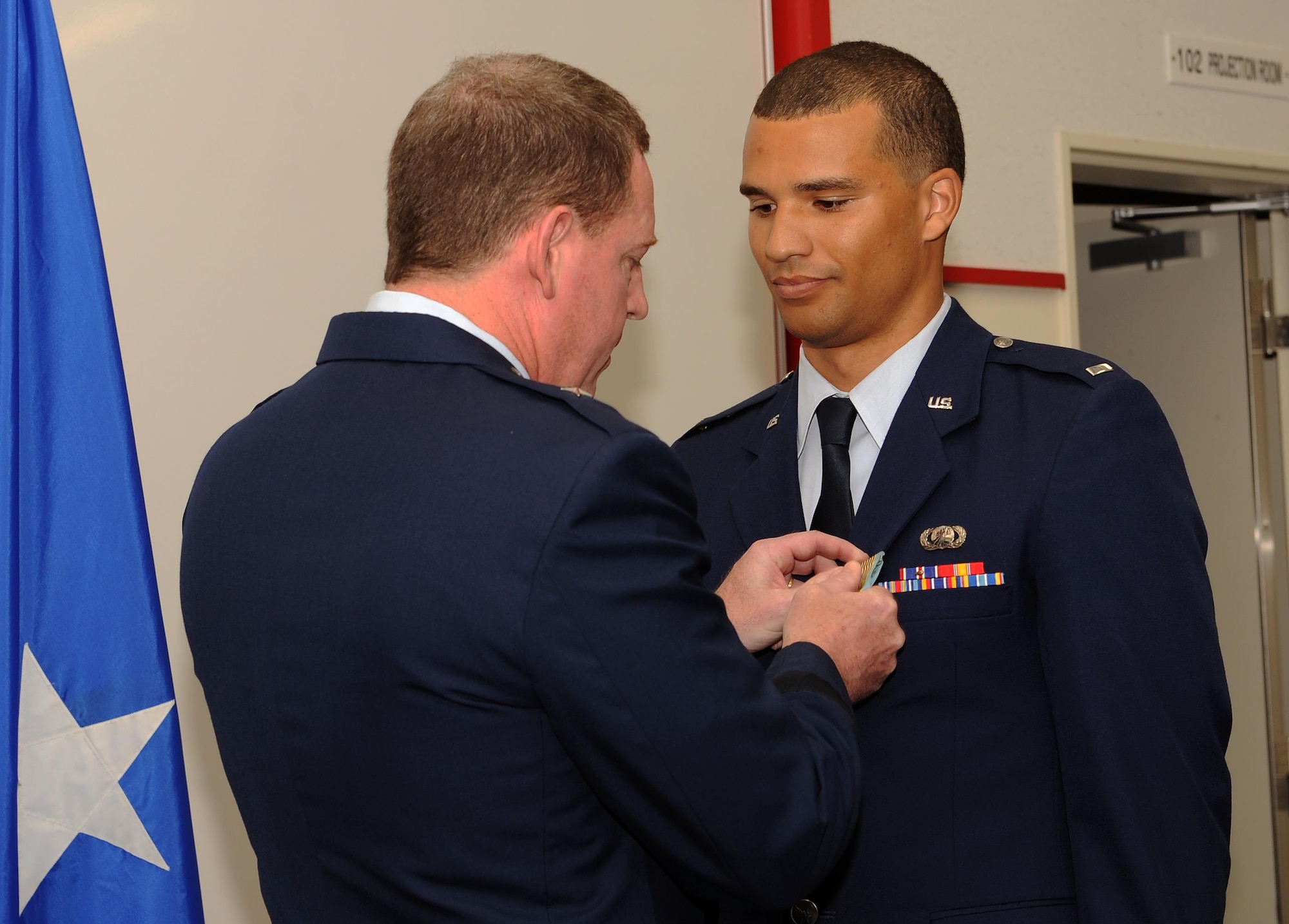 Brig. Gen. James B. Hecker pins the Airman’s Medal on 1st Lt. Dayton Gilbreath during a ceremony March 20, 2015, on Kadena Air Base, Japan. The Airman’s Medal is the Air Force’s highest noncombat honor, and is awarded to service members of any country or branch who, while serving in any capacity with the Air Force, distinguish themselves by heroic actions in a non-combat environment. Hecker is the commander of the 18th Wing and Gilbreath is a contracting administrator assigned to the 18th Contracting Squadron.  (U.S. Air Force photo/Airman 1st Class Zade C. Vadnais)
