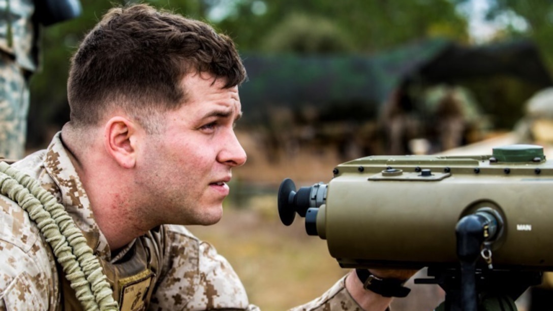 First Lt. Ryan Grogan, a fire support officer with 2nd Battalion, 10th Marine Regiment, 2nd Marine Division, sights in observing the target destined for mortar rounds aboard Fort Bragg, N.C., March 5, 2015. Sighting in to see where rounds will hit, Grogan is familiarizing himself with the digital tracking system.