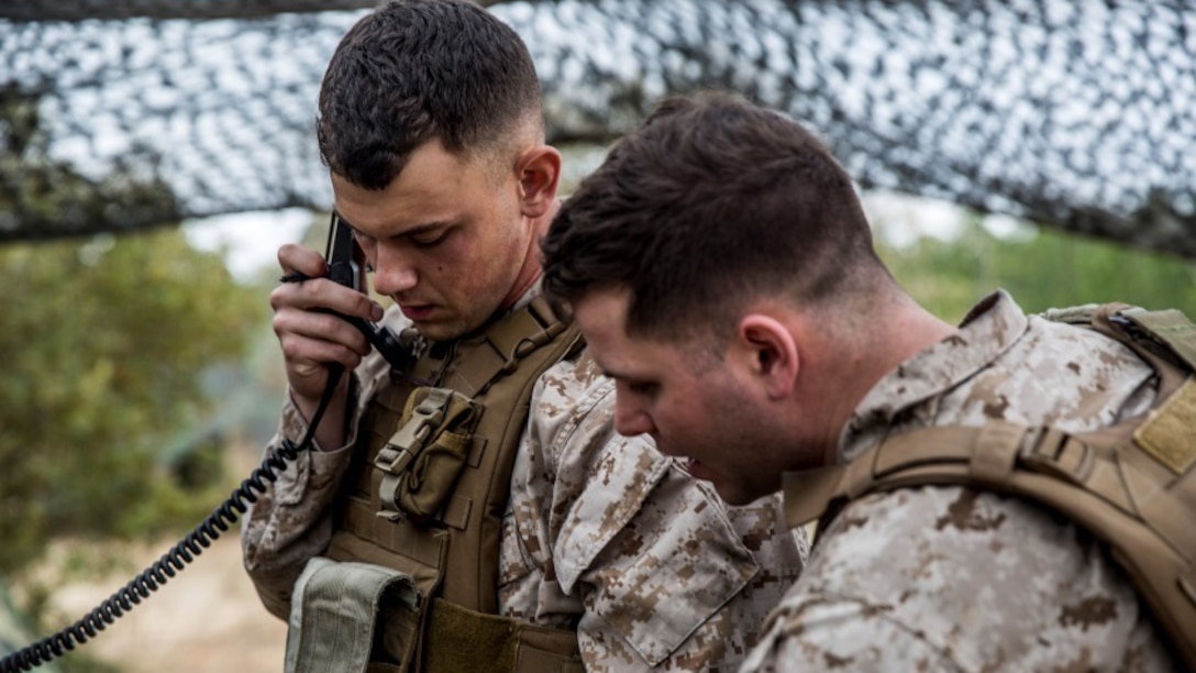 Marines with 2nd Battalion, 10th Marine Regiment, 2nd Marine Division conduct last minute calls to confirm the rounds are ready to be fired during Exercise Rolling Thunder aboard Fort Bragg, N.C., March 5, 2015. Cpl. Zach Harren, left, native of Centerburg, Ohio, is communicating with another battery ensuring that rounds are hitting their intended target.