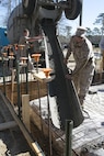 Sgt. Joshua Davis, a combat engineer with 8th Engineer Support Battalion, 2nd Marine Logistics Group and a Philadelphia, Pennsylvania, native, pours concrete to create the foundation for a storage building March 18, 2015, aboard Camp Lejeune, North Carolina. Upon completion, the building will be used to store the unit’s martial arts equipment. Construction skills used in the project are preparing the Marines for an upcoming deployment, on which the engineers will use similar techniques to build schools and other structures. (U.S. Marine Corps photo by Cpl. Elizabeth A. Case/Released) 
