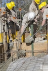 Combat engineers with 8th Engineer Support Battalion, 2nd Marine Logistics Group, use shovels and a concrete vibrator to evenly distribute and remove air pockets from concrete March 18, 2015, aboard Camp Lejeune, North Carolina. “We’re getting ready to deploy, and the way we’re doing this project mirrors the way that we’re going to be building the schools there,” said Sgt. Christopher Panko, a combat engineer with the unit. “It’s giving the Marines good training on the process of what it takes to build from the ground up. As engineers, we normally focus on demolition. The past few years we haven’t done a lot of construction projects, and the Marines haven’t had a chance to do humanitarian work. This is a good opportunity, and with their experience level they’re doing very well.” (U.S. Marine Corps photo by Cpl. Elizabeth A. Case/Released) 
