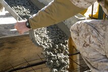 Sgt. Joshua Davis, a combat engineer with 8th Engineer Support Battalion, 2nd Marine Logistics Group and a Philadelphia, Pennsylvania, native, pours concrete at a construction site March 18, 2015, aboard Camp Lejeune, North Carolina, to establish the foundation for a storage facility. Upon completion, the building will be used to store the unit’s martial arts equipment. Construction skills used in the project are preparing the Marines for an upcoming deployment, on which the engineers will use similar techniques to build schools and other structures. (U.S. Marine Corps photo by Cpl. Elizabeth A. Case/Released)