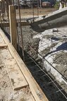 Combat engineers with 8th Engineer Support Battalion, 2nd Marine Logistics Group, poured concrete to create the foundation for a storage facility March 18, 2015, aboard Camp Lejeune, North Carolina. Marines in the unit are constructing the facility to store the unit’s martial arts gear and to further their basic skills in preparation for an upcoming deployment. “We’re getting ready to deploy, and the way we’re doing this project mirrors the way that we’re going to be building the schools there,” said Sgt. Christopher Panko, a combat engineer with the unit. “It’s giving the Marines good training on the process of what it takes to build from the ground up. As engineers, we normally focus on demolition. The past few years we haven’t done a lot of construction projects, and the Marines haven’t had a chance to do humanitarian work. This is a good opportunity, and with their experience level they’re doing very well.” (U.S. Marine Corps photo by Cpl. Elizabeth A. Case/Released) 