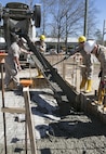 Combat engineers with 8th Engineer Support Battalion, 2nd Marine Logistics Group, use tools to pour concrete into a foundation, March 18, 2015, aboard Camp Lejeune, North Carolina. Upon completion, this building will be a storage facility for the unit’s martial arts equipment. “We’re getting ready to deploy, and the way we’re doing this project mirrors the way that we’re going to be building the schools there,” said Sgt. Christopher Panko, a combat engineer with the unit. “It’s giving the Marines good training on the process of what it takes to build from the ground up. As engineers, we normally focus on demolition. The past few years we haven’t done a lot of construction projects, and the Marines haven’t had a chance to do humanitarian work. This is a good opportunity, and with their experience level they’re doing very well.”  (U.S. Marine Corps photo by Cpl. Elizabeth A. Case/Released) 