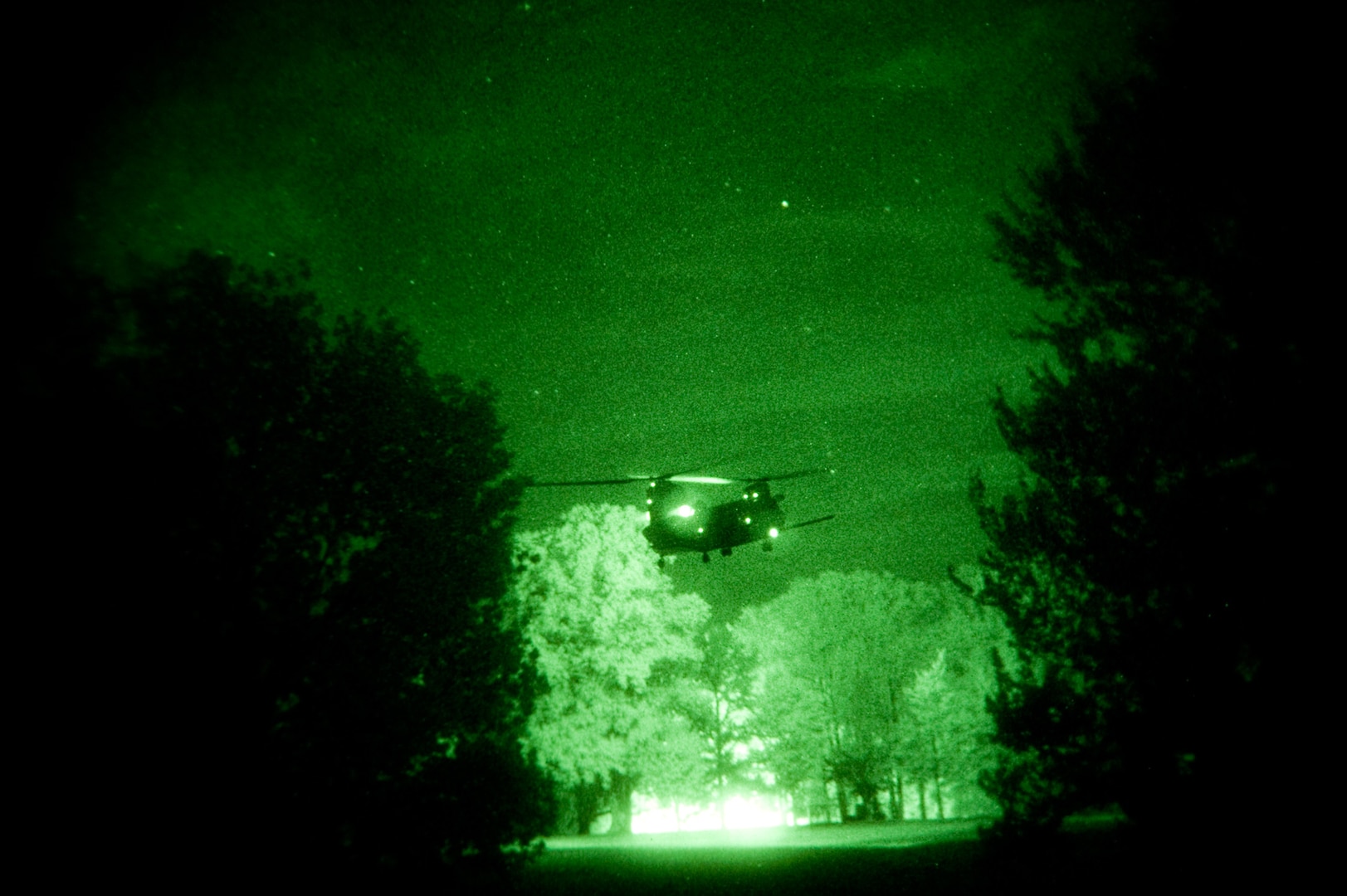 Seen through a night vision lens, a CH-47 Chinook helicopter from the 160th Special Operations Aviation Regiment lands in a field during night operations at Muscatatuck Urban Training Center, Ind.,June 10, 2010.