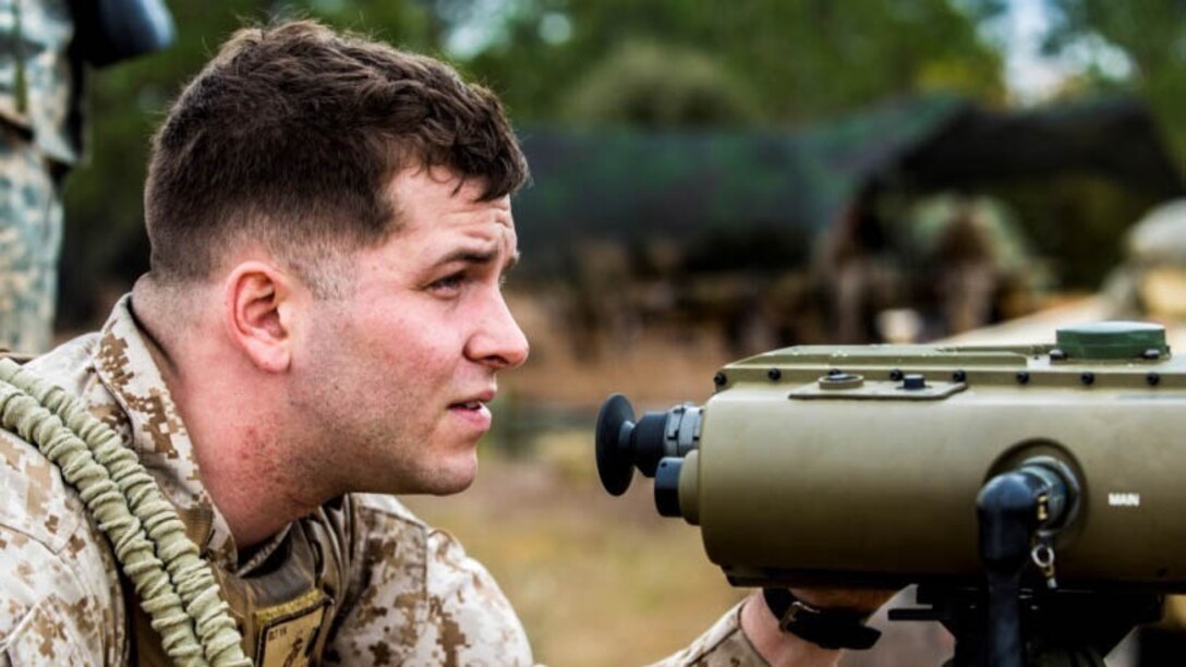 First Lt. Ryan Grogan, a fire support officer with 2nd Battalion, 10th Marine Regiment, 2nd Marine Division, sights in observing the target destined for mortar rounds aboard Fort Bragg, N.C., March 5, 2015. Sighting in to see where rounds will hit, Grogan is familiarizing himself with the digital tracking system.