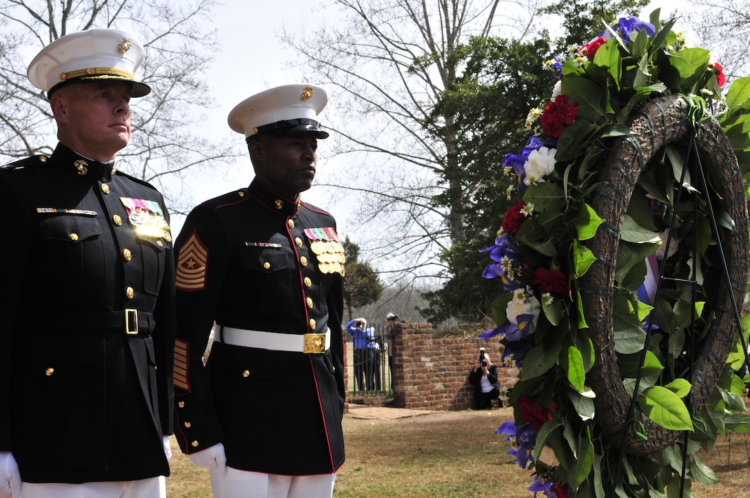 Col. David W. Maxwell, commander, Marine Corps Base Quantico, and Sgt. Maj. Mark A. Byrd Sr., base sergeant major, stand at attention after placing a wreath at the grave site of President James Madison during Monday’s ceremony at Montpelier to commemorate the 264th birthday of the nation’s fourth president.