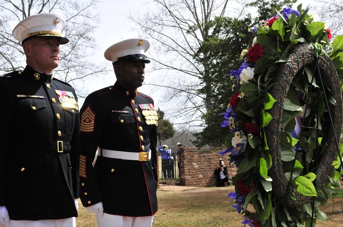Col. David W. Maxwell, commander, Marine Corps Base Quantico, and Sgt. Maj. Mark A. Byrd Sr., base sergeant major, stand at attention after placing a wreath at the grave site of President James Madison during Monday’s ceremony at Montpelier to commemorate the 264th birthday of the nation’s fourth president.