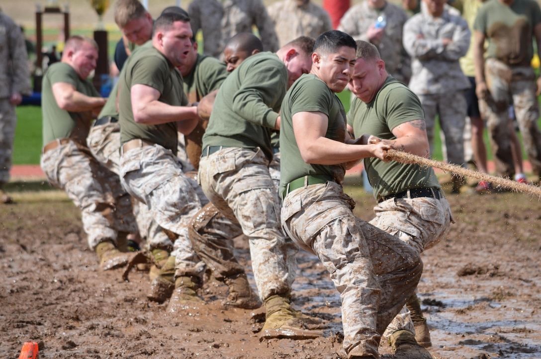 Teams of 10 went head to head in a tug-of-war competition in a giant mud pit adjacent to Butler Stadium during the Navy and Marine Corps Relief Society field meet Friday.