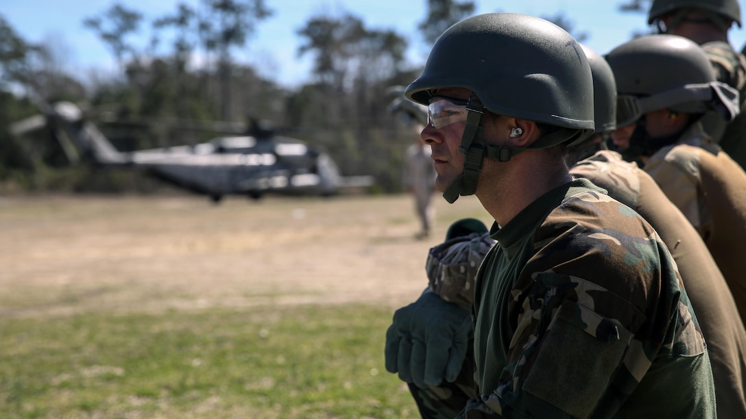 Royal Dutch Marines with the Royal Netherlands Marine Corps wait in a line before boarding a CH-53 E Super Stallion to conduct a fast-roping exercise at the  Expeditionary Operations Training Group compound at Stone Bay  aboard Marine Corps Base Camp Lejeune, North Carolina, March 17, 2015.  During the exercises, Royal Marines practiced fast-roping with no gear, full gear including weapons and packs, and conducted  a tactical entry to secure a perimeter around the landing zone.