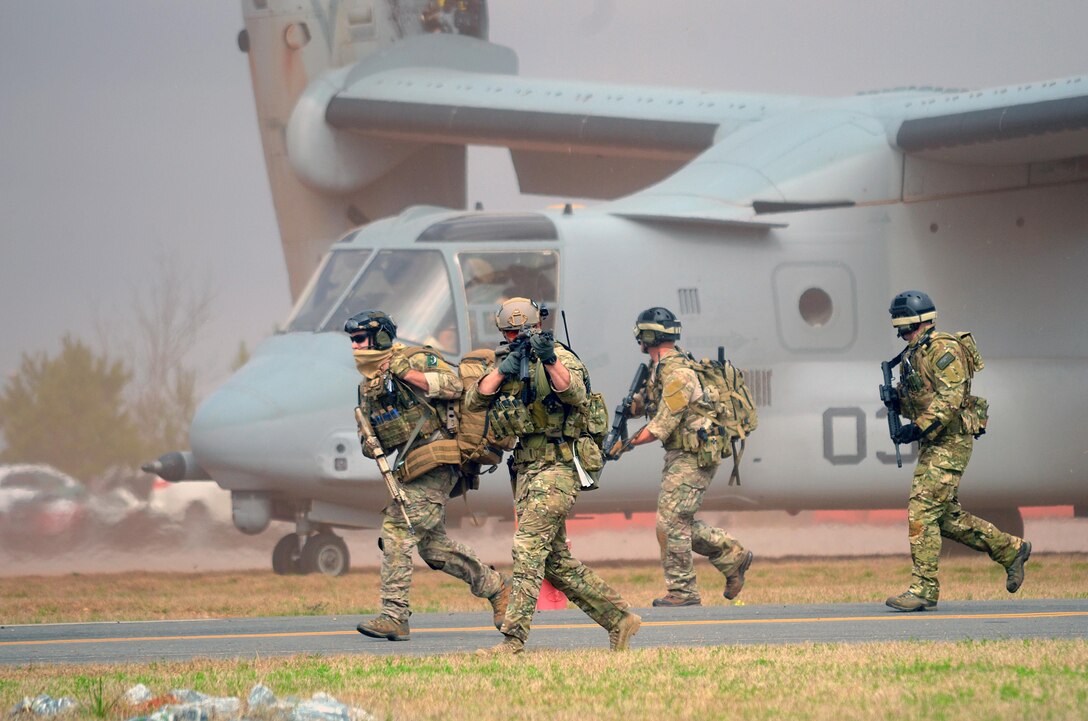 Pararescue jumpers and combat rescue officers conduct joint training with the 7th Special Forces Group March 11, 2015, in Perry, Ga. The four-day exercise used HH-60 Pave Hawks and MV-22 Ospreys for simulated scenarios that included earthquake collapsed buildings, vehicle-borne improved explosive devices detonating, and mass casualty response. The pararesue jumpers and rescue officers are from the 920th Rescue Wing at Patrick Air Force Base, Fla. (U.S. Air Force photo/Staff Sgt. Kelly Goonan)