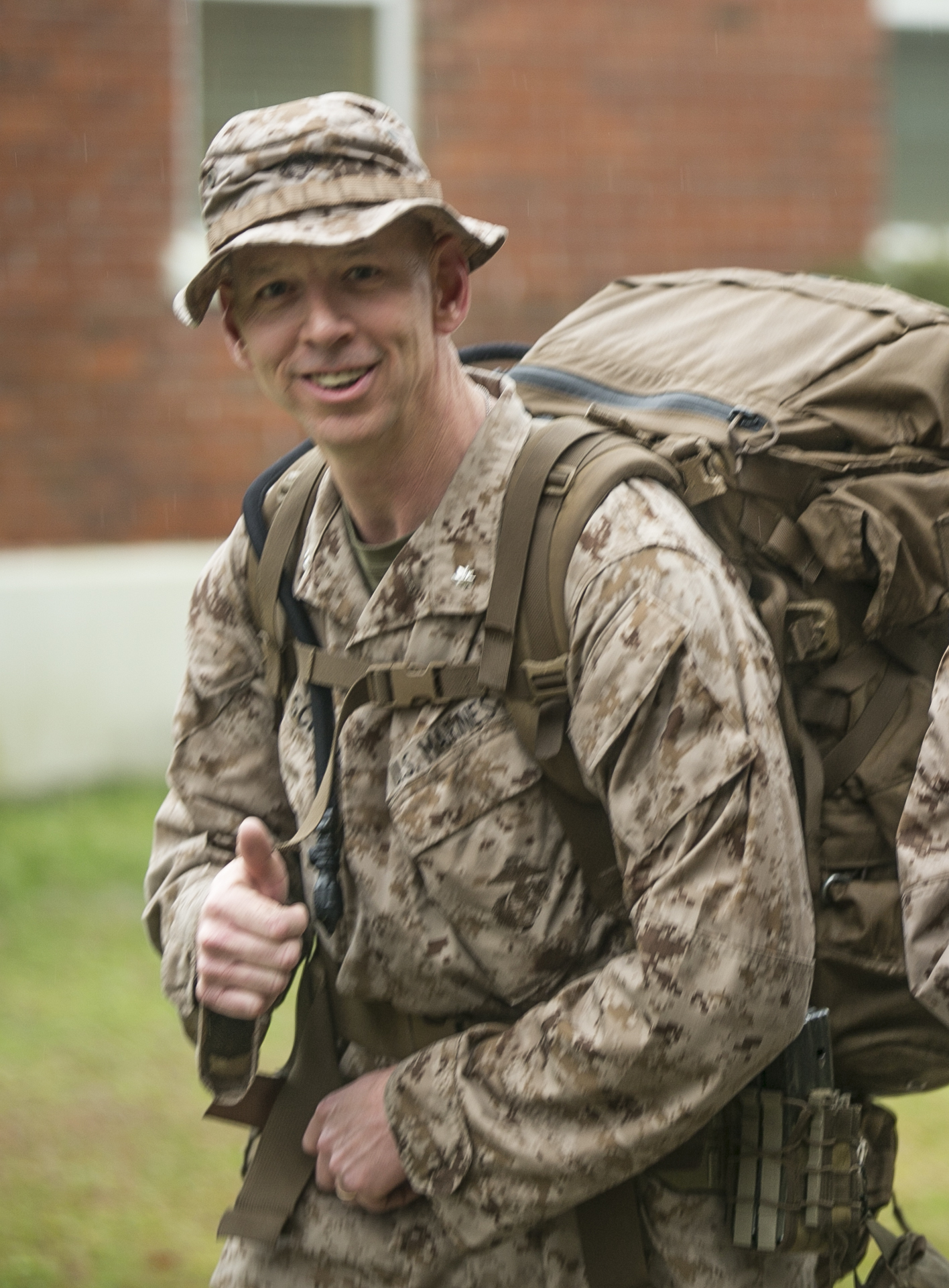 Lt. Col. Joel F. Schmidt, the battalion commander for 2nd Battalion, 2nd Marine Regiment, gives a thumbs-up as the unit nears the end of their nine-mile hike aboard Camp Lejeune, North Carolina, March 20, 2015. The unit conducted the march in preparation for an upcoming rotation to Okinawa, Japan, as part of the unit deployment program. (U.S. Marine Corps photo by Cpl. Elizabeth A. Case/Released)