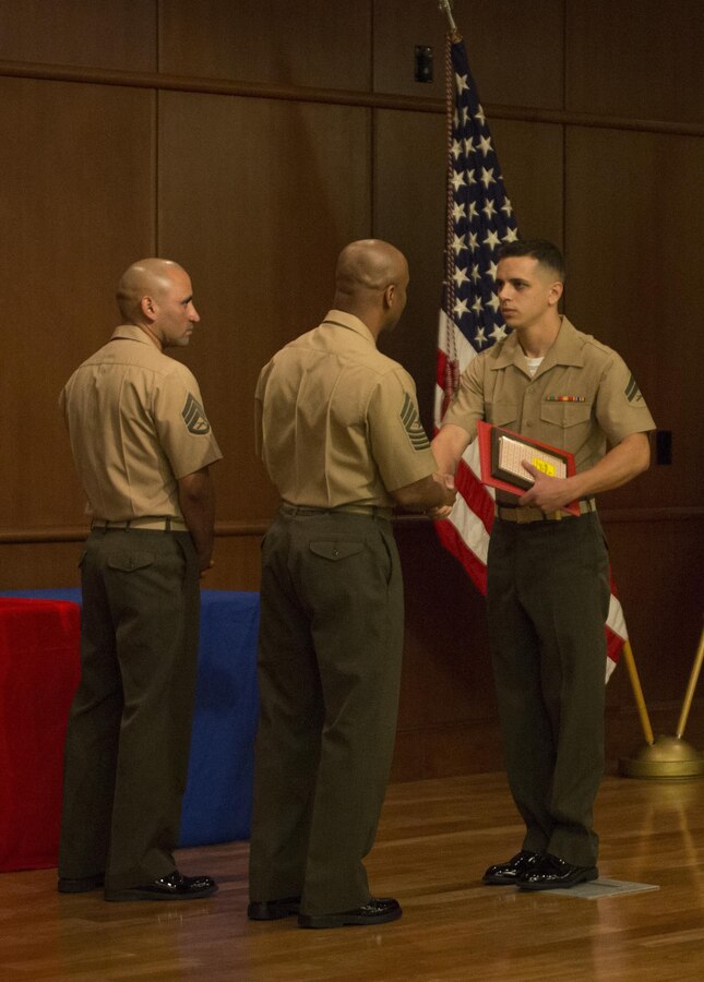 Corporal Joshua Parker, a Marine Air-Ground Task Force clerk with the 4th Marine Logistics Group, receives his diploma for graduating Corporal’s Course from Sgt. Maj. Gary Smith, sergeant major of 4th MLG, at Marine Corps Support Facility New Orleans, March 20, 2015. Parker was recognized as the honor graduate for his outstanding effort during the course. (U.S. Marine Corps photo by Gabrielle Quire)