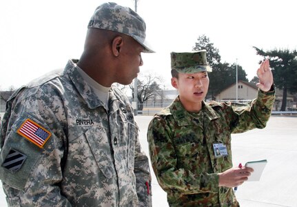 In this file photo, 1st Lt. Matsuaki Saruya, 1st Logistics Support Regiment, Japanese Ground Self Defense Force, and Sgt. 1st Class Luis Rivera, noncommissioned officer in charge, Army Field Support Battalion-Northeast Asia, discuss the Inland Petroleum Distribution System during a logistics terrain walk at Sagami General Depot, Japan. 