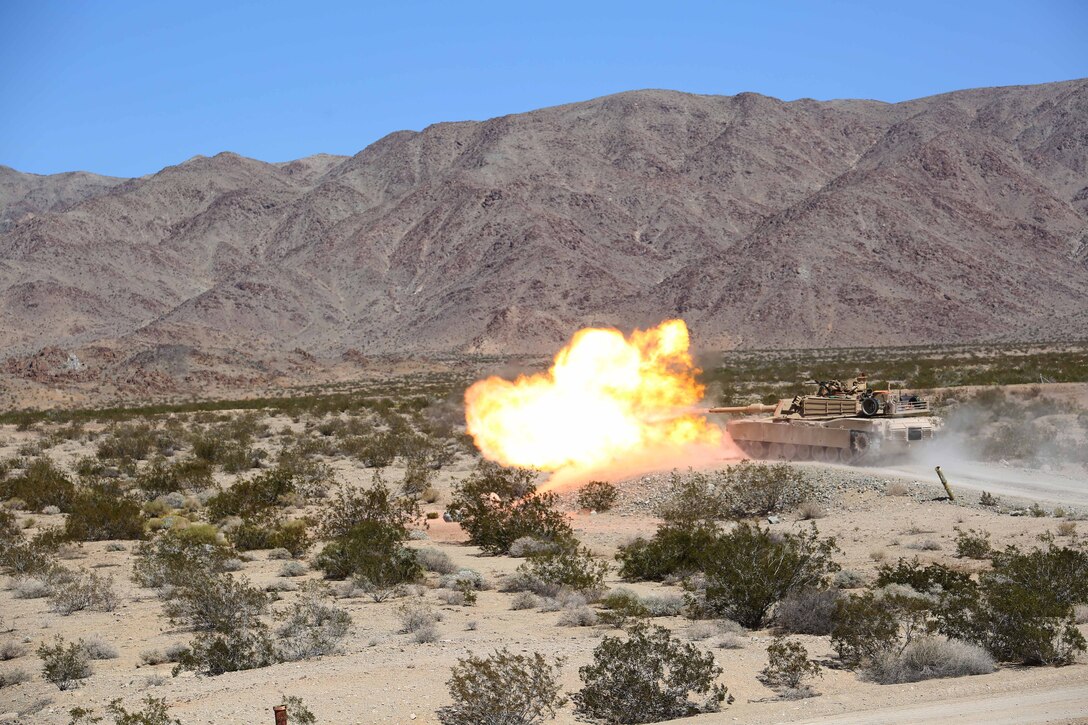 Marines with Tank Platoon, Company B, Ground Combat Element Integrated Task Force, fire their 120mm M1A1 Abrams tank main gun during a Marine Corps Operational Test and Evaluation Activity assessment at Range 500, Marine Corps Air Ground Combat Center Twentynine Palms, California, March 7, 2015. From October 2014 to July 2015, the GCEITF will conduct individual and collective level skills training in designated ground combat arms occupational specialties in order to facilitate the standards-based assessment of the physical performance of Marines in a simulated operating environment performing specific ground combat arms tasks. (U.S. Marine Corps photo by Cpl. Paul S. Martinez/Released)