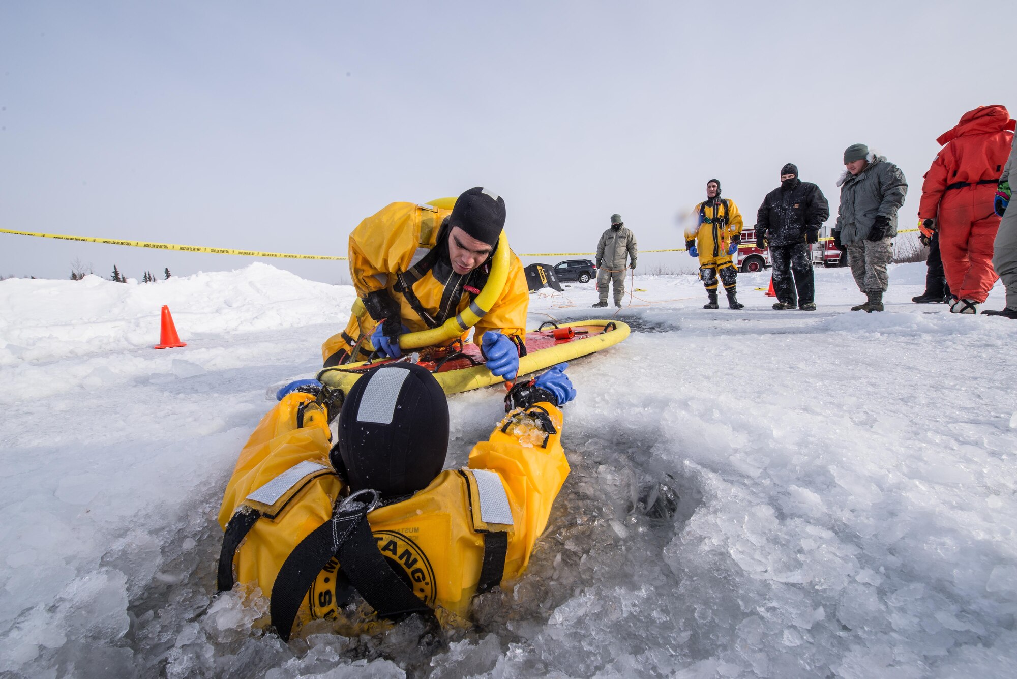 U.S. Air Force Airman 1st Class Israel Hernandez, a 354th Civil Engineer Squadron firefighter, prepares to rescue a simulated victim trapped in freezing water during training on Eielson Air Force Base, Alaska, March 12, 2015. Fire protection Airmen from the 354th CES train annually to practice rescuing a victim trapped in a broken part of a frozen lake. (U.S. Air Force photo by Staff Sgt. Joshua Turner/Released)