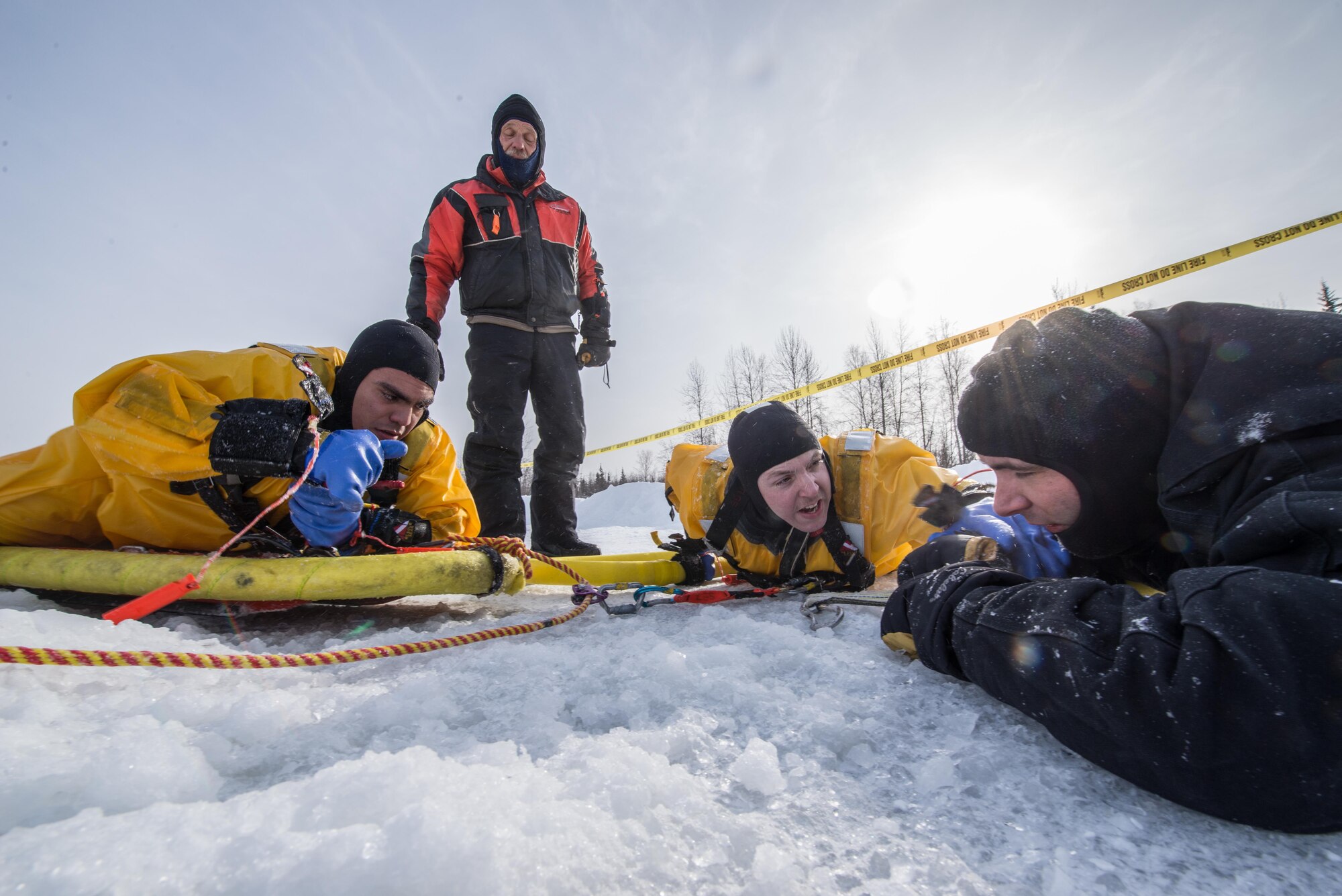 U.S. Air Force Aiman 1st Class Israel Hernandez and Tech. Sgt. Eric Peperissa, both firefighters with the 354th Civil Engineer Squadron, prepare to rescue a simulated victim during training on Eielson Air Force Base, Alaska, March 12, 2015. Fire protection Airmen from the 354th CES train annually to practice rescuing a victim trapped in a broken part of a frozen lake. (U.S. Air Force photo by Staff Sgt. Joshua Turner/Released)