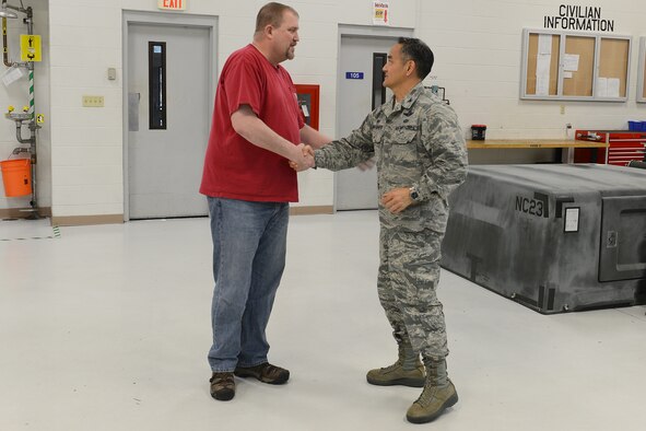 Col. David Kumashiro, 62nd Airlift Wing commander, announces the selection of Matthew Zubrod as the Air Mobility Command’s Civilian of the Year, Category IIb, Mar. 20, 2015, at Joint Base Lewis-McChord, Wash. Zubrod, 62nd Maintenance Squadron powered support system supervisor, was also chosen as the Team McChord civilian of the year category IIb on March 6 at the Annual Award Banquet. (U.S. Air Force photo/Staff Sgt. Tim Chacon)