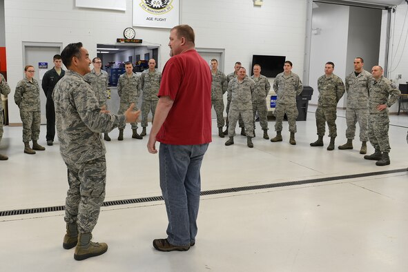 Col. David Kumashiro, 62nd Airlift Wing commander, announces the selection of Matthew Zubrod, as the Air Mobility Command’s civilian of the year, Category IIb, Mar. 20, 2015, at Joint Base Lewis-McChord, Wash. Dring 2014, Zubrod, 62nd Maintenance Squadron powered support system supervisor, led three generator overhauls which eliminated more than $215,000 in depot costs and extended the units life by 20 years. He oversaw 1,100 maintenance actions and 300 periodic inspections that anchored a 96% in-commission rate. (U.S. Air Force photo/ Staff Sgt. Tim Chacon)