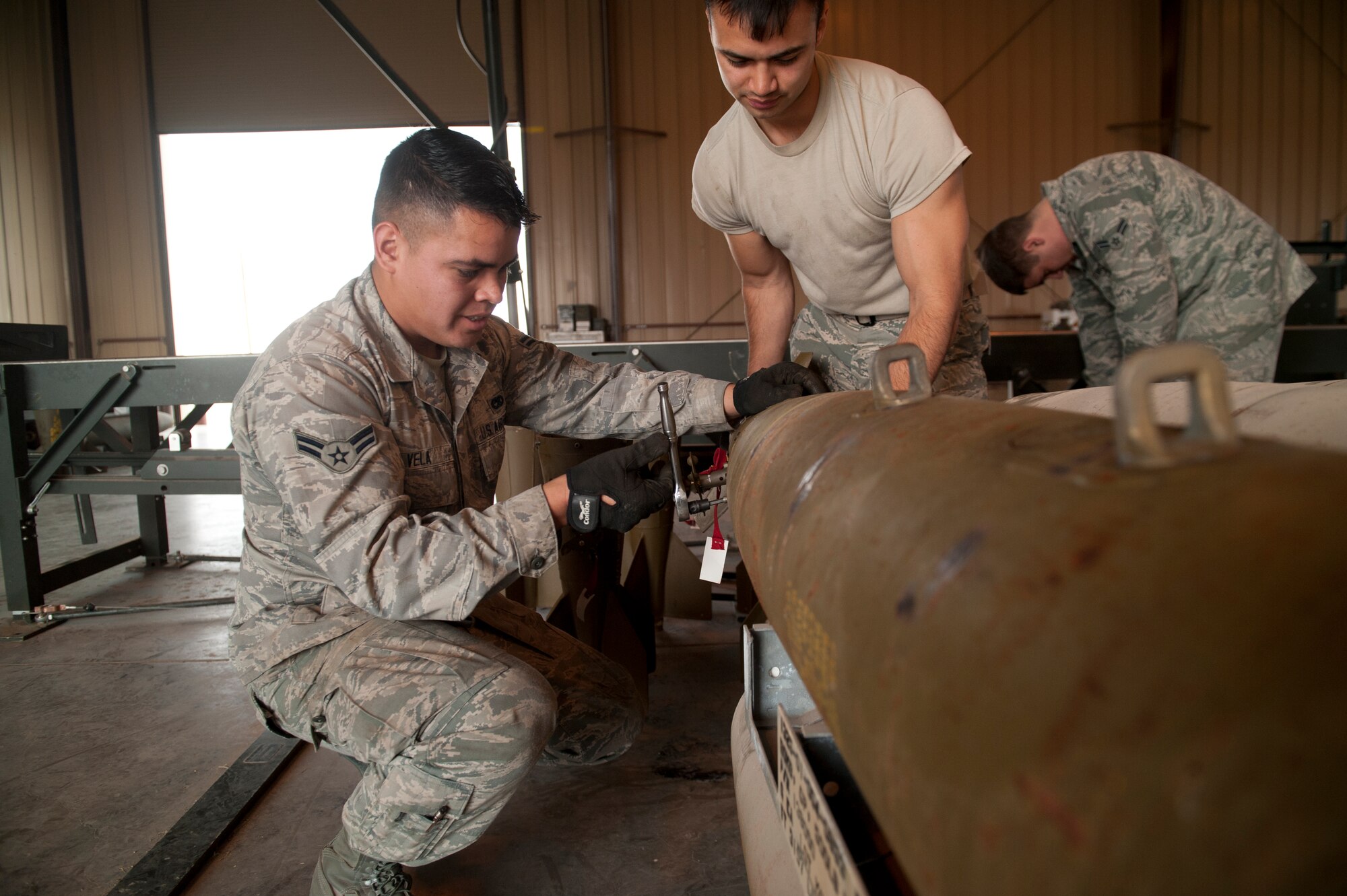 Airman 1st Class Ernesto Vela and Airman 1st Class Matthew Lopez, 49th Wing Conventional Munitions Crew Members, attach the tail fin of the Mark 82 bomb that will be used for training with new F-16 Aircraft pilots under the 54th Fighter group at Holloman Air Force Base/White Sands Missile Range, N.M., March 17, 2015. The 54th is a newly activated training group that specializes in training F-16 Aircraft pilots for future deployments. The Mark 82 is the perfect munition for training in a controlled environment, and has a rich history dating back to before the Vietnam War.