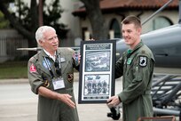 Retired Air Force Col. Mike Brazelton, former Vietnam War POW, and Maj. Joe Elam, 560th Flying Training Squadron evaluator pilot, display the Freedom Flight photo of the first POW Flight of Four during the 560th Flying Training Squadron Artifact Dedication ceremony and open house March 20 at Joint Base San Antonio-Randolph. The annual event, in conjunction with the 42nd Freedom Flyer Reunion and 18th Annual POW/MIA Symposium, honors all POWs held captive during the Vietnam War. The tradition began when members of the 560th Flying Training Squadron were given the task to retrain more than 150 POWs returning to flying status. Brazelton’s aircraft was shot down during a mission over North Vietnam Aug. 7, 1966, and was held captive by the North Vietnamese until his release March 4, 1973. (U.S. Air Force Photo by Johnny Saldivar/released)