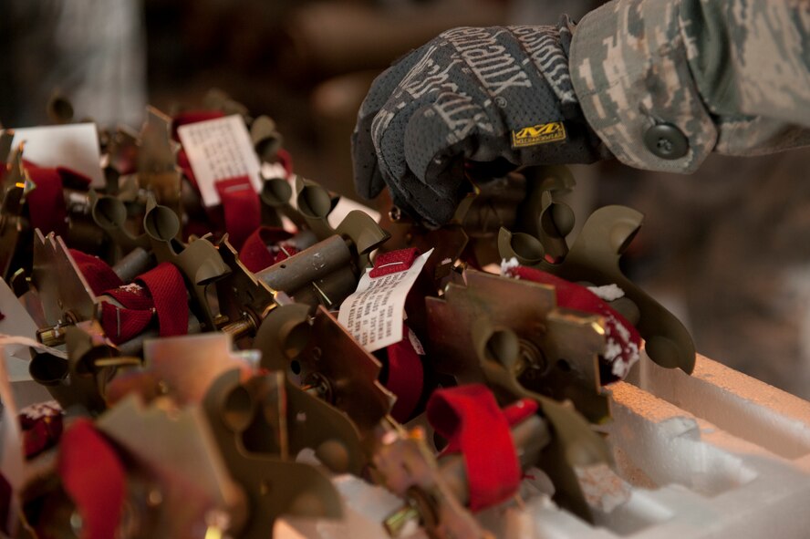 Airman 1st Class Joshua Baldridge, 49th Wing Conventional Munitions Crew Member, reaches for part of a Mark 82 bomb during a routine weapons build for F-16 training missions at Holloman Air Force Base, N.M., March 17, 2015. The Mark 82 is used during the flight training of new F-16 aircraft pilots at Holloman/White Sands Missile Range under the 54th Fighter Group. The Mark 82 is a 500 pound munition that has been in use since the late 1960s, making it one of the most versatile weapons in the U.S. military and a perfect option for training missions. 
